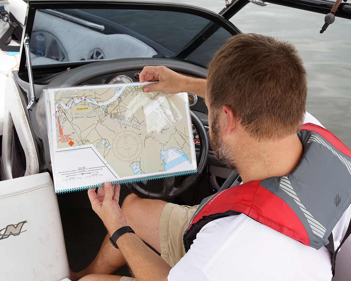 Photos: Captain Using Navigation Charts - Water Sports Foundation