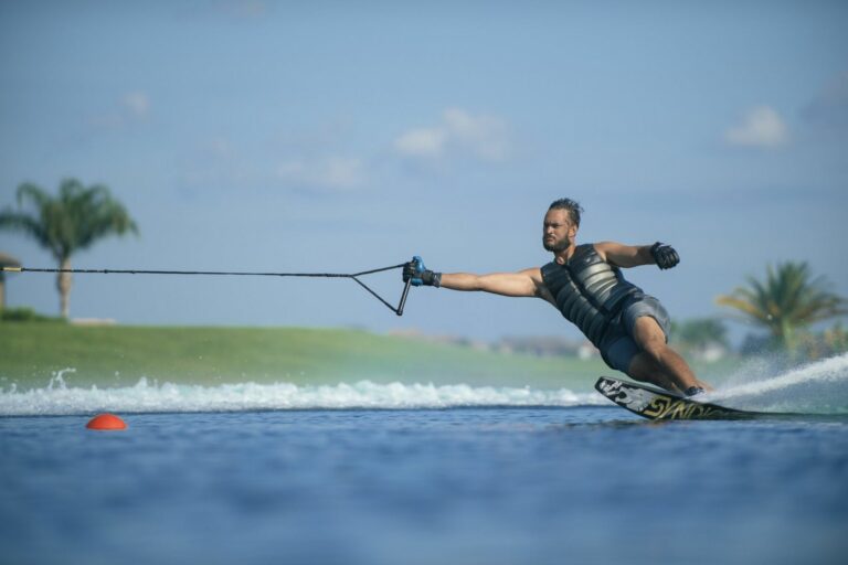 Man water skiing with a single grip.