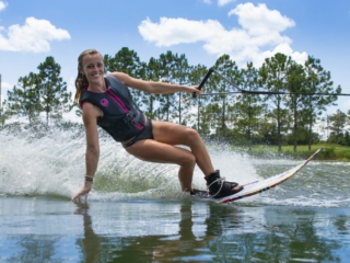 Woman water skiing on a single waterski