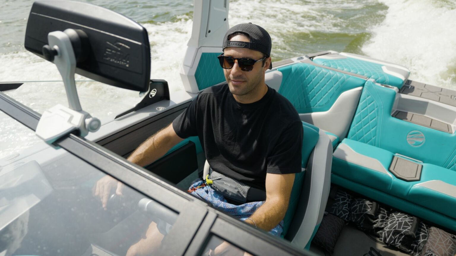 License-free image - Captain of a ski boat driving while safely observing for other nautical traffic. 