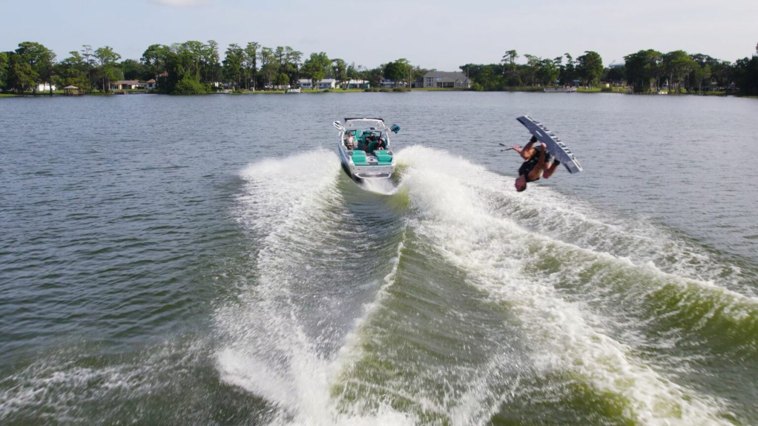 License-free image - Wakeboarder flipping the wake behind a wake boat