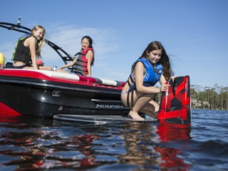 Kids having fun on the water in properly fitting life jackets.