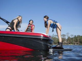 Kids having fun on the water in properly fitting life jackets.