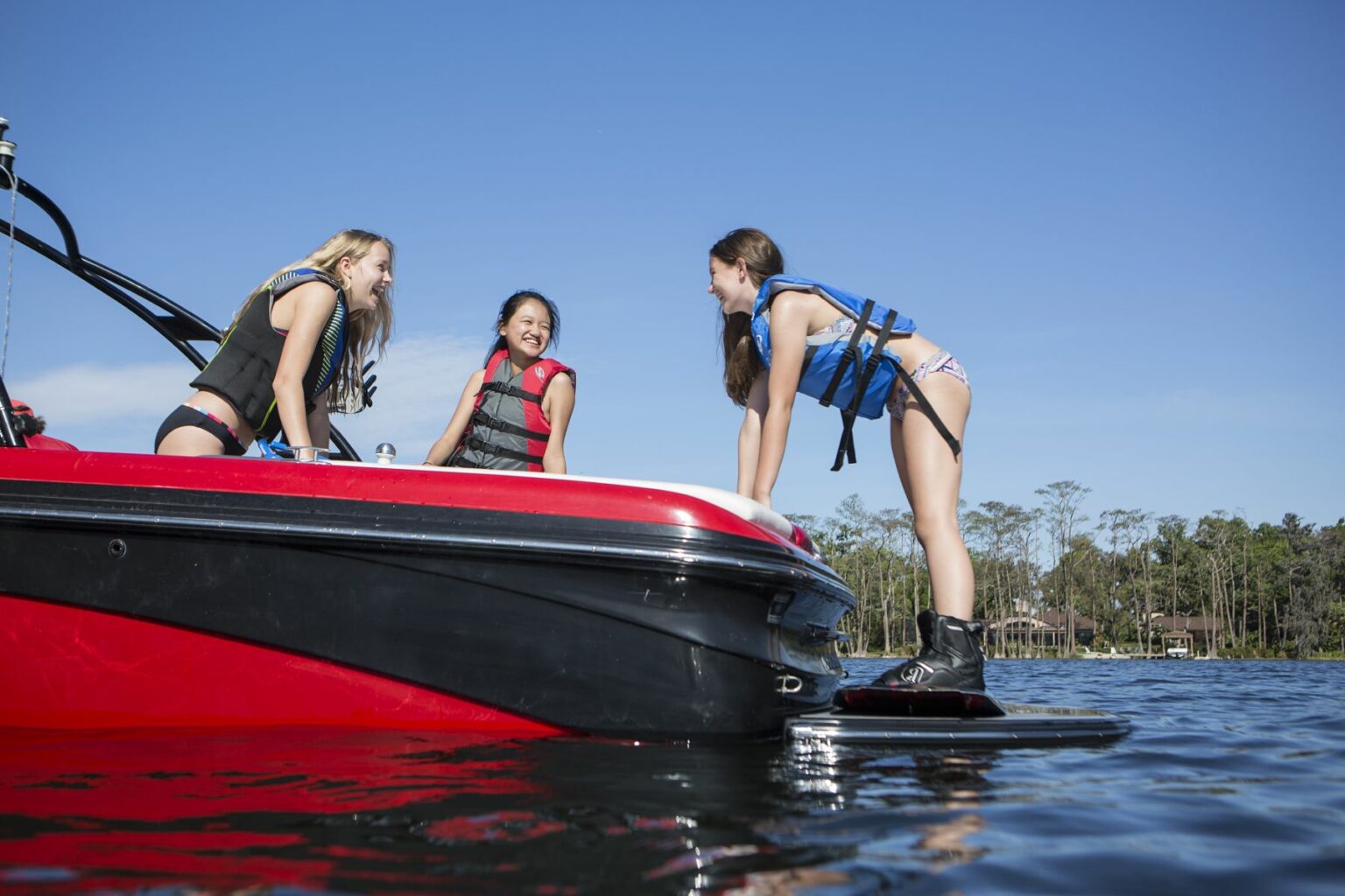 Kids having fun on the water in properly fitting life jackets.