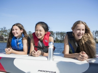 Kids having fun on the water in properly fitting life jackets.