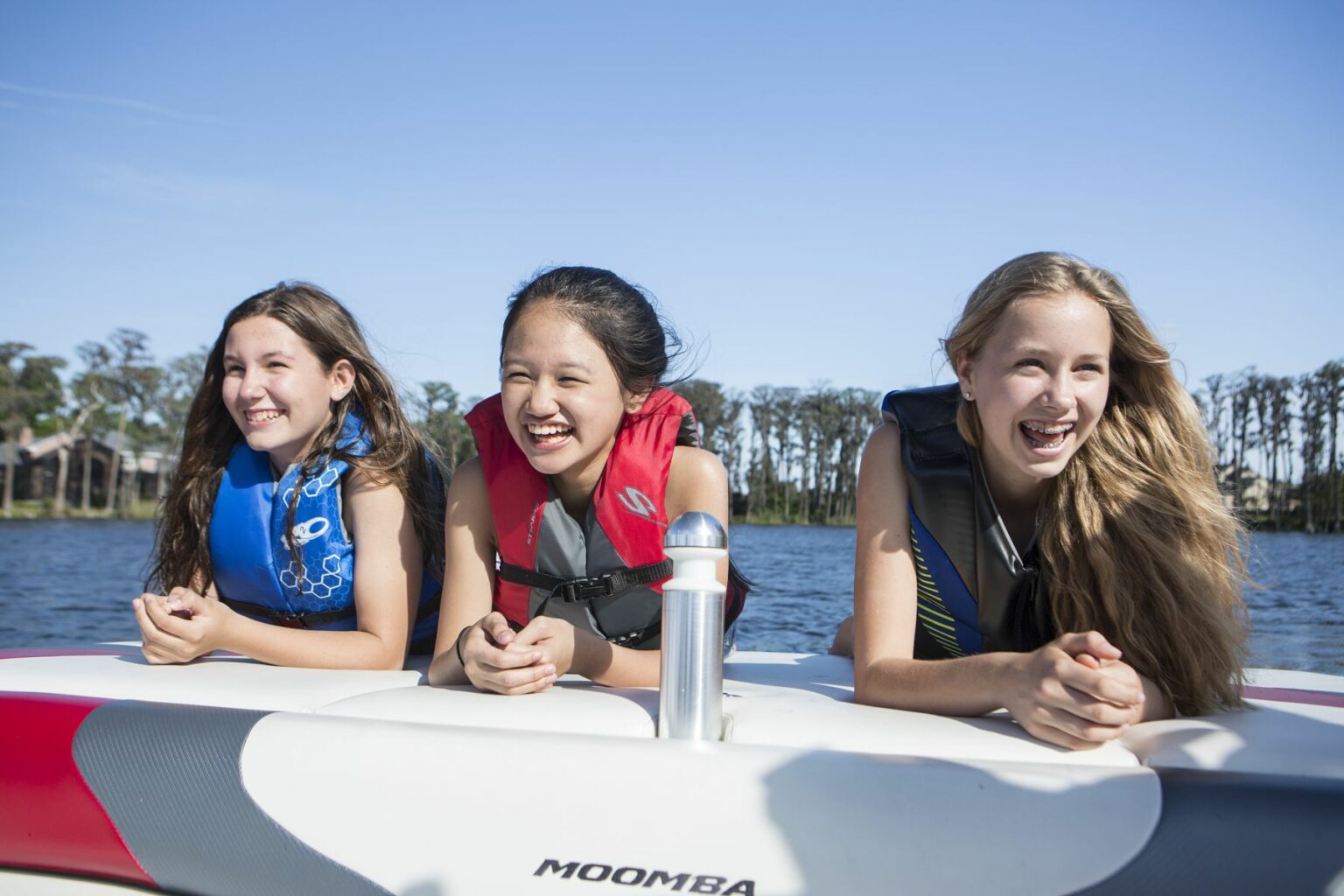 Kids having fun on the water in properly fitting life jackets.