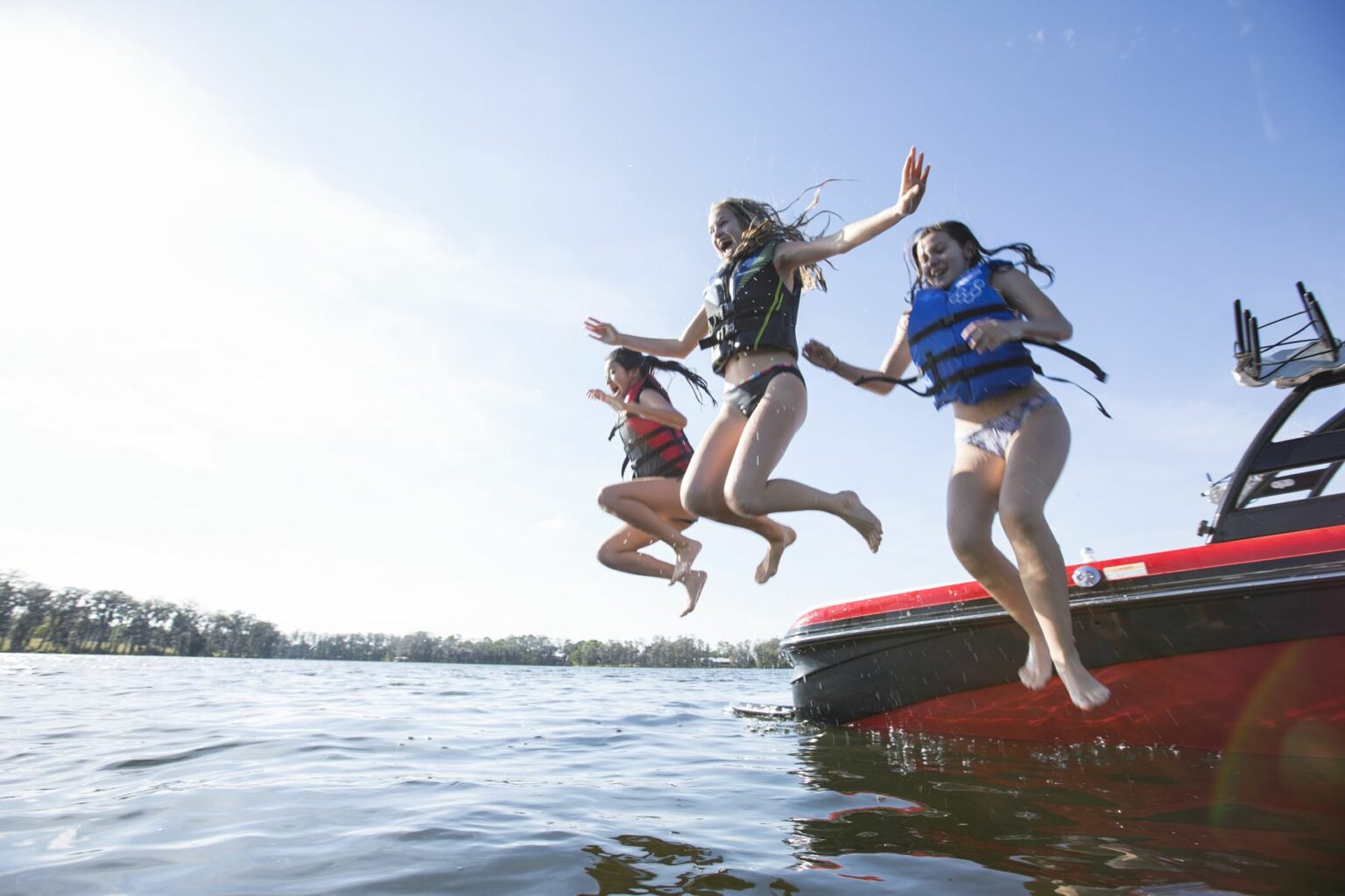 Kids having fun on the water in properly fitting life jackets.